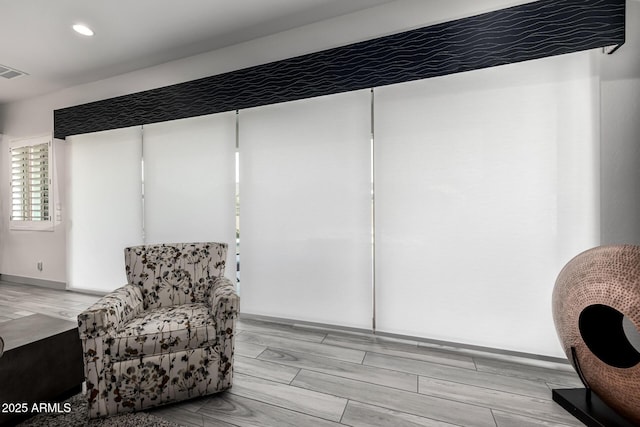 sitting room with recessed lighting and wood finish floors