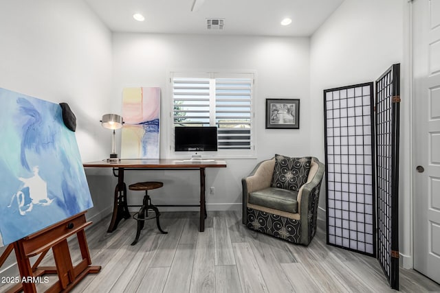 office featuring wood finished floors, baseboards, and recessed lighting