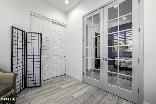doorway to outside with french doors, light wood-style floors, recessed lighting, and baseboards