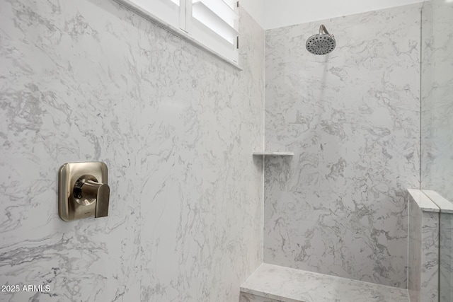 bathroom view of a marble finish shower