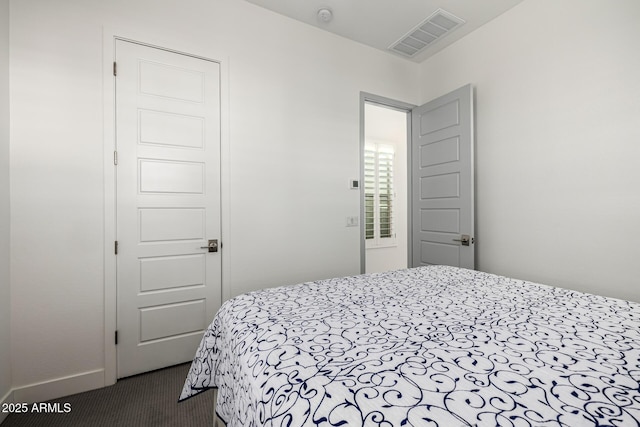 bedroom with dark colored carpet