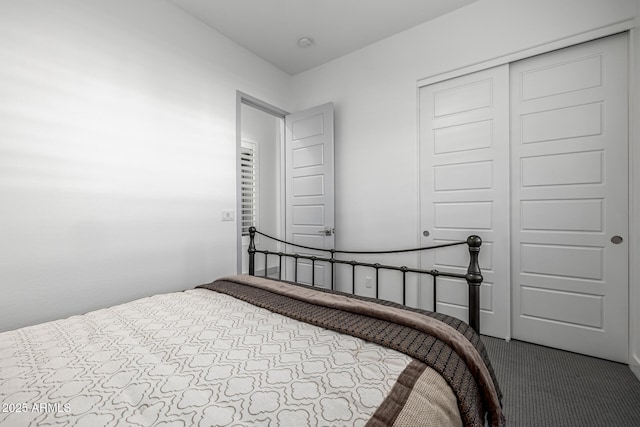 bedroom with dark carpet and a closet