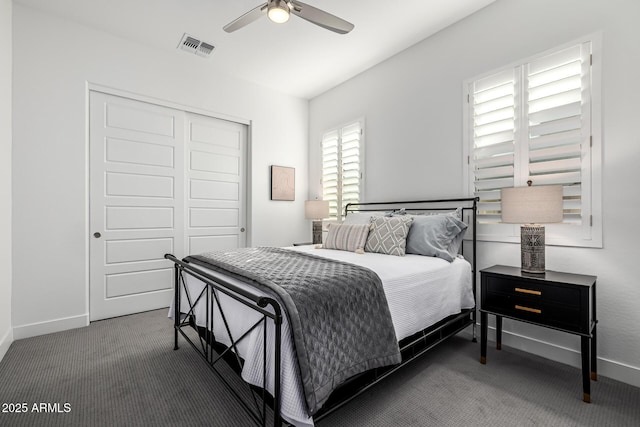 carpeted bedroom with a closet, baseboards, and a ceiling fan