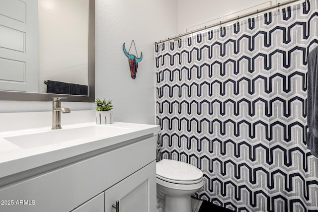 bathroom with toilet, vanity, and a shower with curtain
