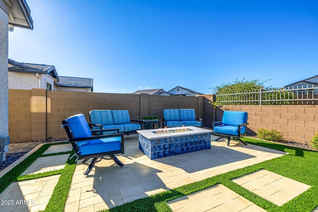 view of patio / terrace with an outdoor living space with a fire pit and a fenced backyard
