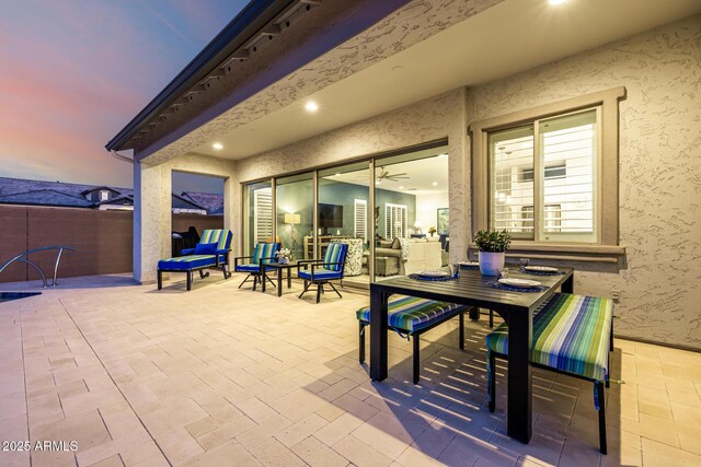view of patio with outdoor dining space and fence