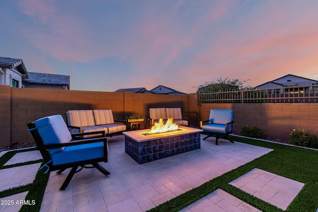 view of patio featuring an outdoor fire pit and a fenced backyard