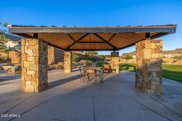view of property's community with a gazebo, a patio area, and outdoor dining area