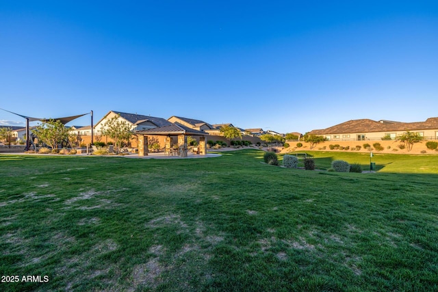 view of green lawn with a gazebo and a residential view