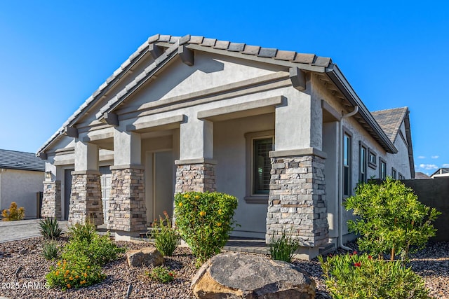 view of front of home featuring stone siding and stucco siding
