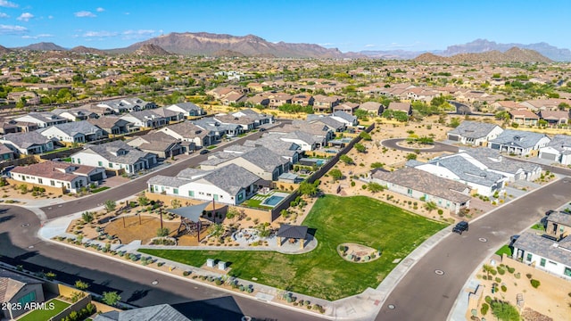 aerial view of property's location featuring a mountain backdrop and nearby suburban area