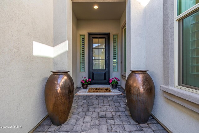 property entrance with stucco siding