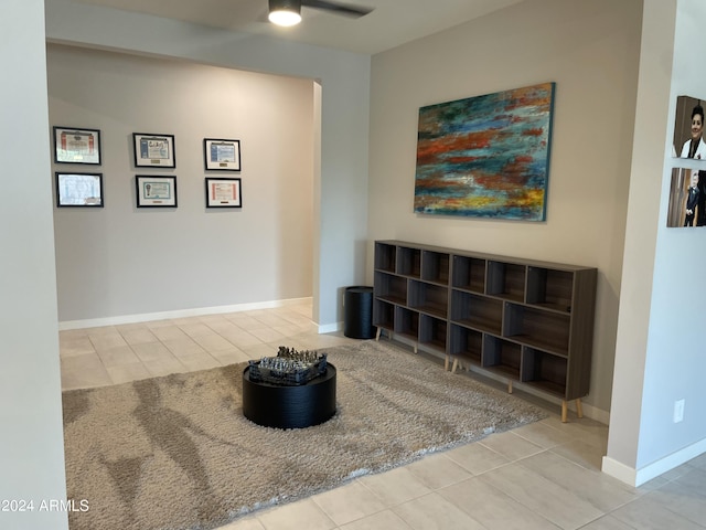 living area with baseboards and tile patterned floors