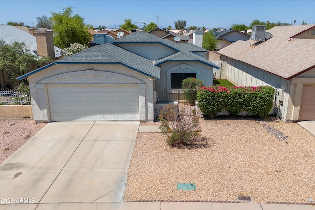 6938 W Nicolet Ave, Glendale, AZ 85303 - view of front of property featuring an attached garage, concrete driveway, stucco siding, a residential view, and central air condition unit