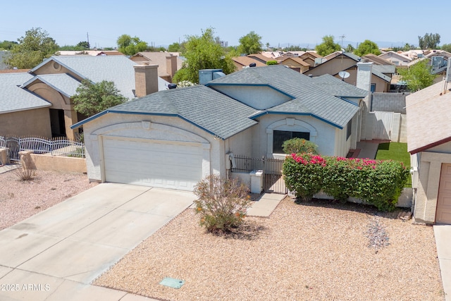 6938 W Nicolet Ave, Glendale, AZ 85303 - view of front facade featuring a fenced front yard, roof with shingles, and a garage