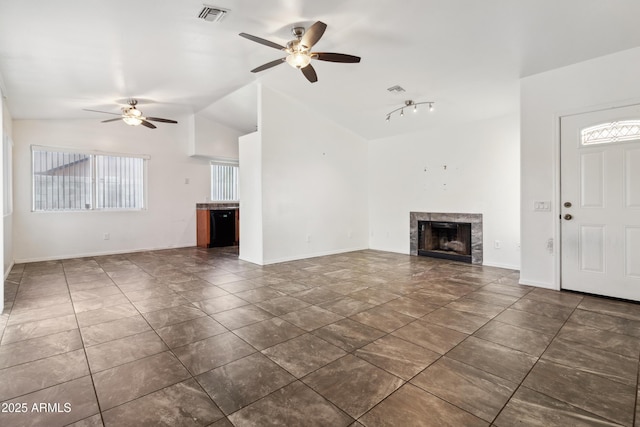 6938 W Nicolet Ave, Glendale, AZ 85303 - unfurnished living room with a ceiling fan, lofted ceiling, a tile fireplace, and baseboards