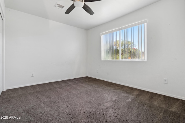 6938 W Nicolet Ave, Glendale, AZ 85303 - unfurnished room featuring a ceiling fan, dark carpet, and baseboards