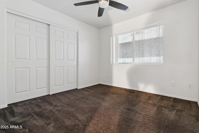 6938 W Nicolet Ave, Glendale, AZ 85303 - unfurnished bedroom with dark colored carpet, a closet, and a ceiling fan
