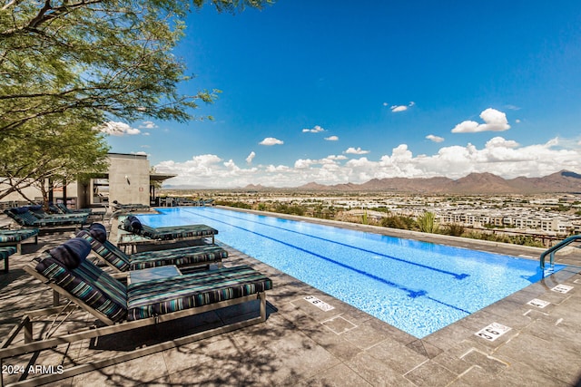 view of swimming pool with a mountain view