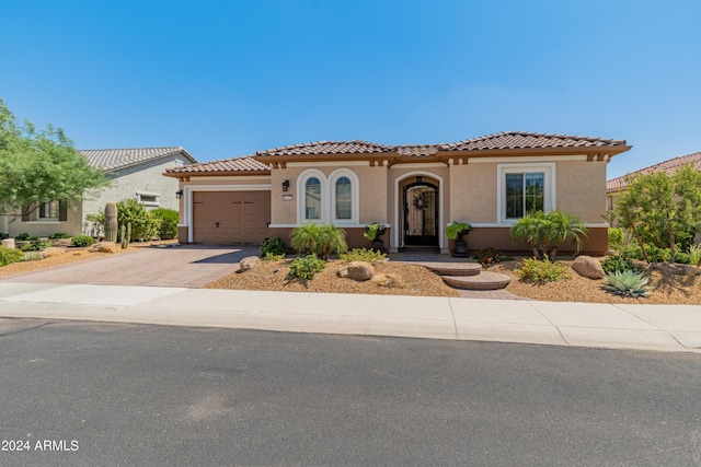 mediterranean / spanish-style home with a garage