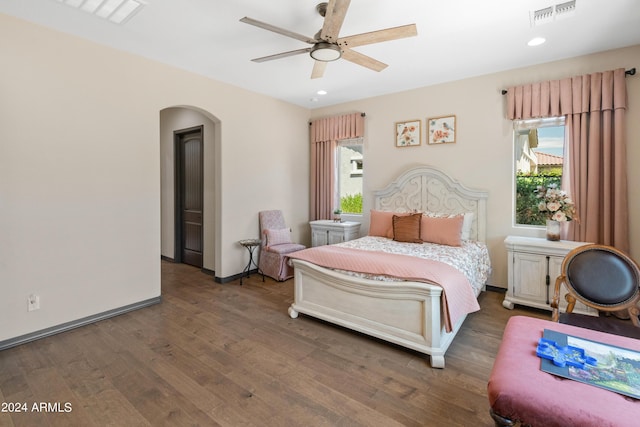 bedroom with dark hardwood / wood-style floors and ceiling fan