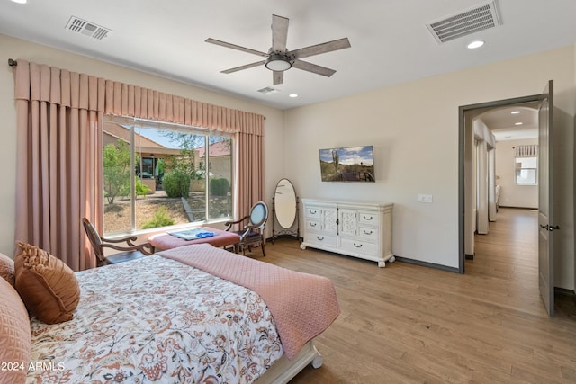 bedroom with light hardwood / wood-style floors and ceiling fan