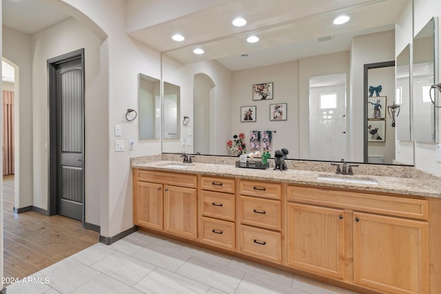 bathroom with walk in shower and vanity