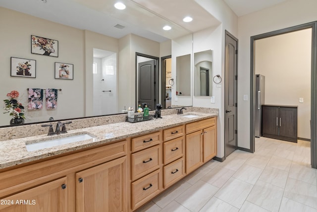 bathroom featuring vanity and a shower