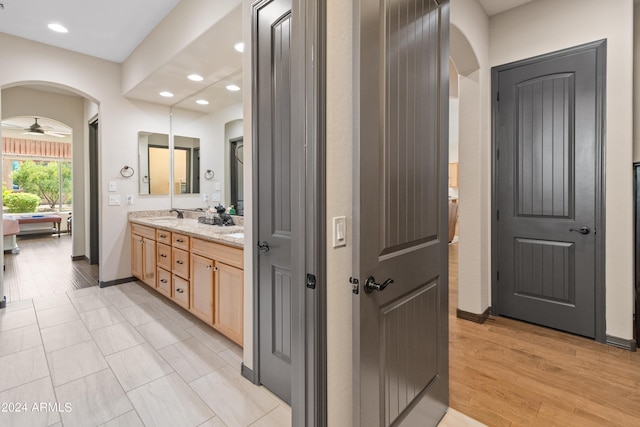 bathroom with vanity, wood-type flooring, and ceiling fan