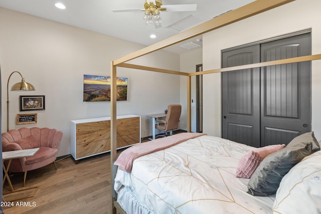 bedroom with hardwood / wood-style flooring, ceiling fan, and a closet