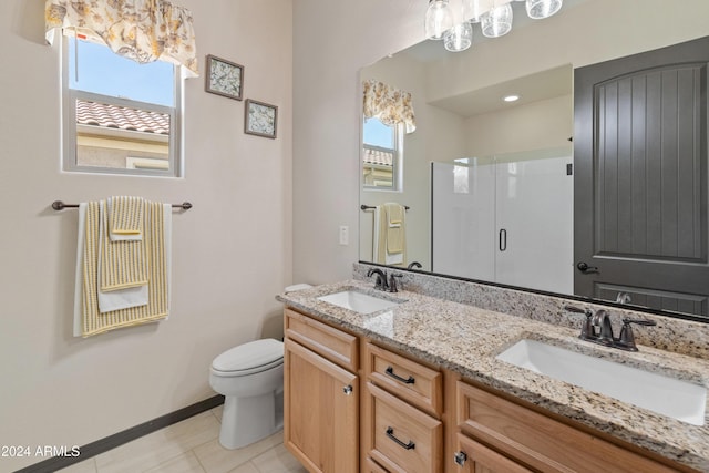 bathroom with a healthy amount of sunlight, toilet, an enclosed shower, and vanity