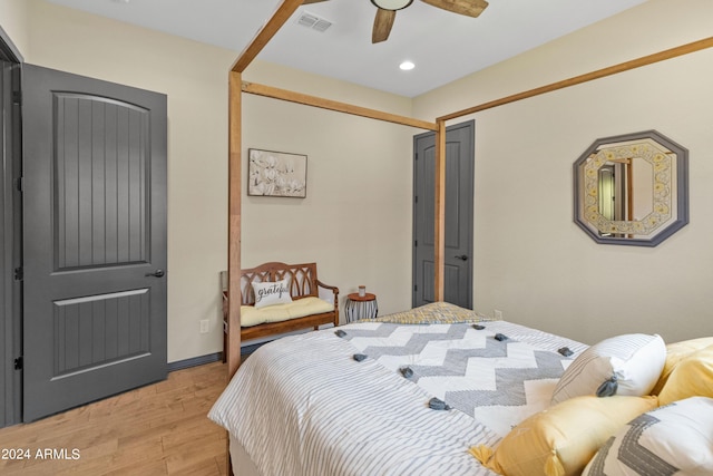 bedroom with ceiling fan, light hardwood / wood-style floors, and a closet