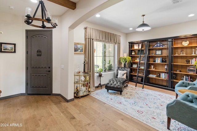 sitting room with beam ceiling and light hardwood / wood-style flooring