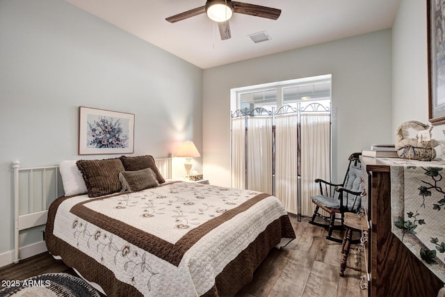 bedroom with visible vents, ceiling fan, and wood finished floors