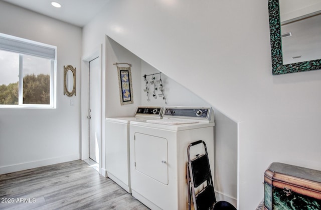 clothes washing area with washer and clothes dryer, recessed lighting, light wood-type flooring, and baseboards