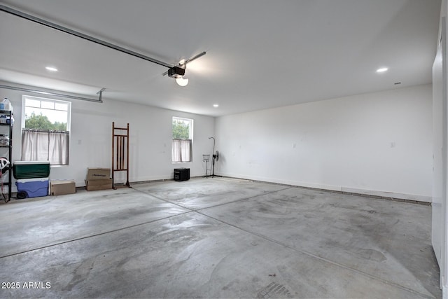 garage featuring recessed lighting and baseboards