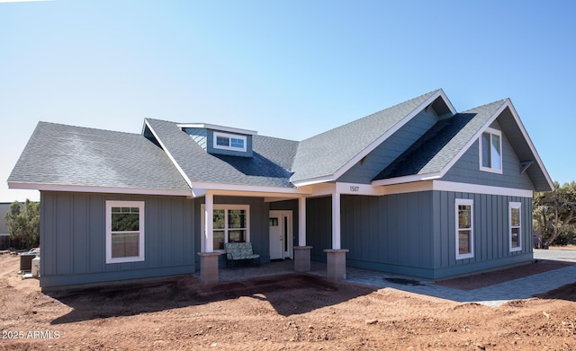 view of front facade featuring a porch, board and batten siding, and a shingled roof