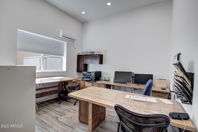 office space with recessed lighting, light wood-style flooring, and a wall mounted AC