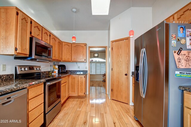 625 Shadow Mountain Dr, Prescott, AZ 86301 - kitchen featuring dark stone countertops, hanging light fixtures, appliances with stainless steel finishes, and light wood-style floors