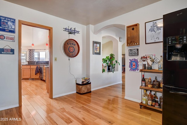625 Shadow Mountain Dr, Prescott, AZ 86301 - corridor featuring light wood-style flooring, arched walkways, and baseboards