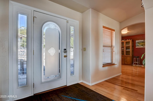 625 Shadow Mountain Dr, Prescott, AZ 86301 - entrance foyer with baseboards, arched walkways, plenty of natural light, and wood finished floors
