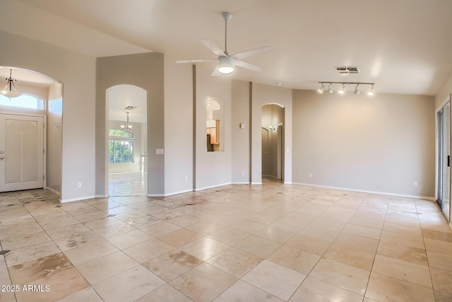 tiled spare room with vaulted ceiling, track lighting, and ceiling fan