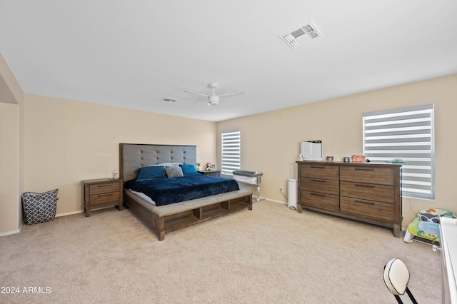 bedroom featuring light colored carpet and ceiling fan