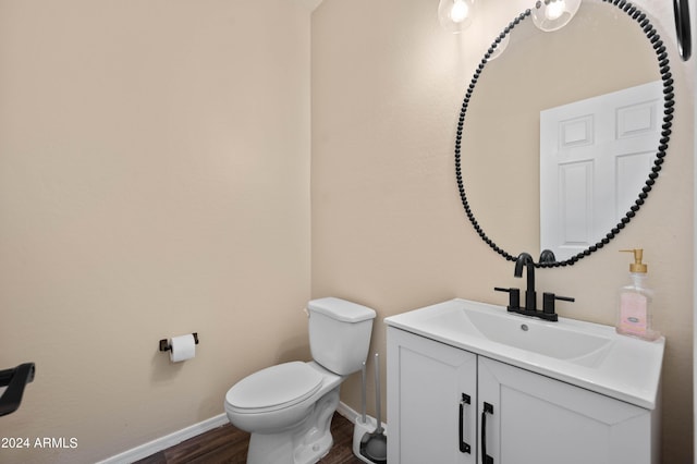 bathroom featuring hardwood / wood-style flooring, vanity, and toilet