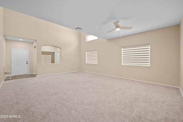 unfurnished room with ceiling fan and light carpet