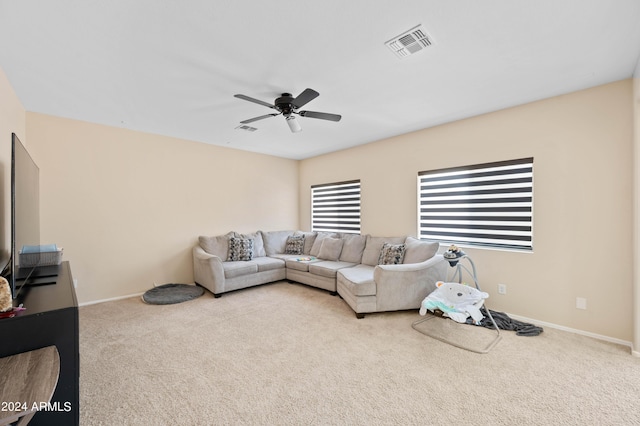 carpeted living room with ceiling fan