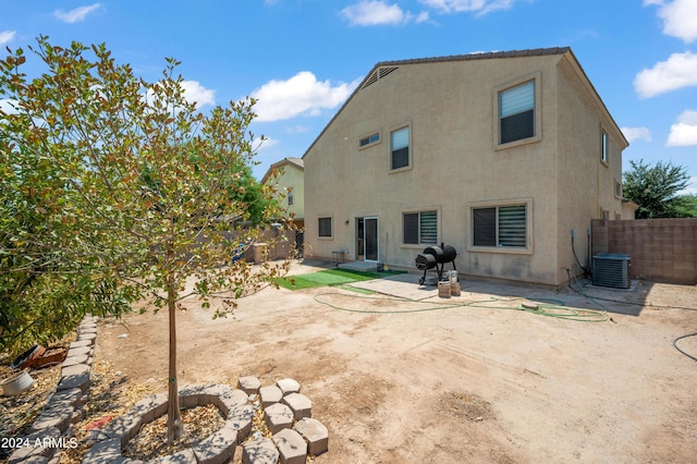 rear view of house with a patio and cooling unit