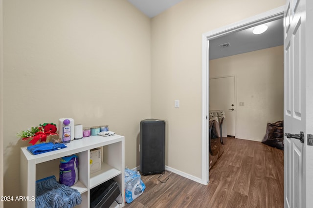 interior space featuring wood-type flooring and independent washer and dryer