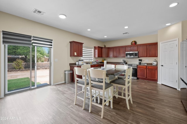 dining area with dark hardwood / wood-style flooring and sink