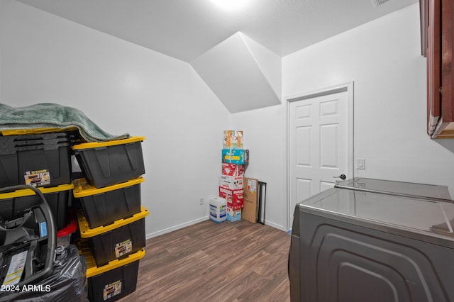 laundry room with cabinets, dark hardwood / wood-style floors, and washing machine and clothes dryer